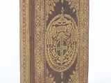 the front cover of a book with a gold design on it