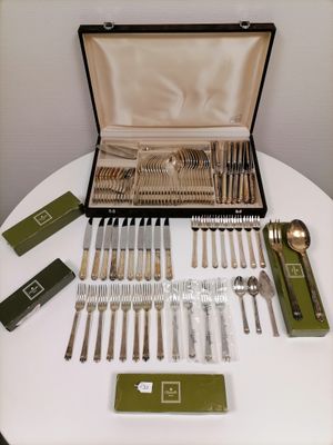 a table with silverware on it and a case full of silverware