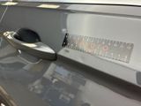 a close up of a car door handle with a sticker on it