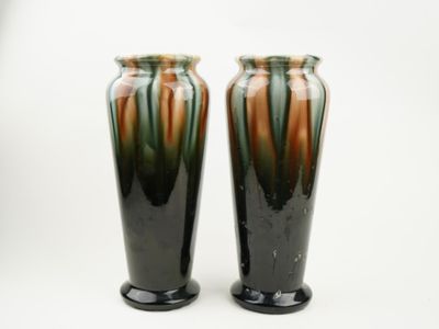 pair of black and green vases on a white background