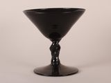 a black wine glass with a twisted stem on a table