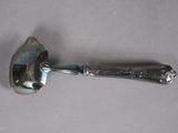 a silver spoon with a handle on a table