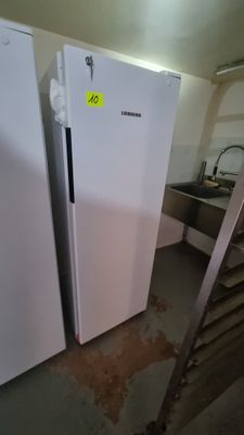 two white refrigerators in a kitchen next to a staircase