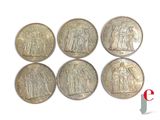 six silver coins with the image of jesus and other figures on them