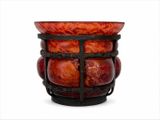 un vase rouge posé sur un socle