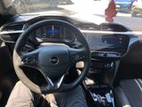 someone is sitting in the driver ' s seat of a car with their feet on the steering wheel