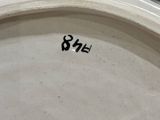a close up of a white plate with numbers on it