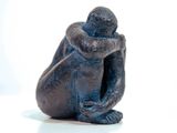 a statue of a monkey that is sitting on a table