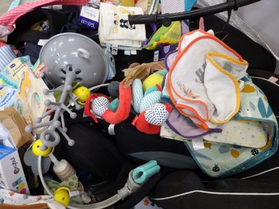 a baby stroller filled with baby items and toys