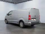 the van is parked in a large room with a white wall