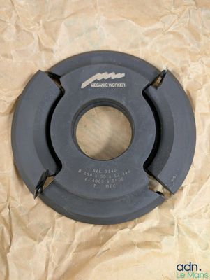 a close up of a black disc on a piece of paper