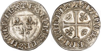 a silver coin with a cross on the front and a shield on the back