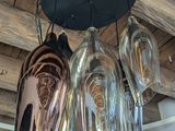many wine glasses hanging from the ceiling in this room
