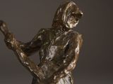 a bronze statue of a man playing a guitar