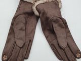 pair of brown leather gloves with fur lined cuffs on a white surface