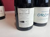 three bottles of wine sitting on a table next to each other