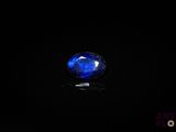 a close up of a blue sapphire stone on a black surface