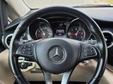 a steering wheel and dashboard of a car on the road