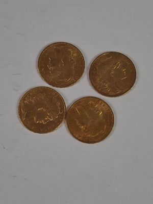 four coins sitting on top of each other on a white surface