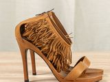 a close up of a pair of shoes with fringes on them