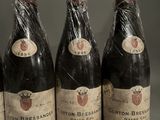 four bottles of wine wrapped in plastic sitting on a table