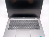 an open laptop computer sitting on top of a white table