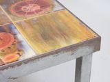 a metal table with a lot of oranges on it