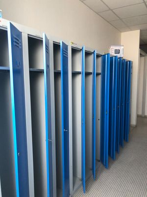 plusieurs casiers bleus sont alignés dans une pièce