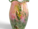 a vase that has a green and pink design on it