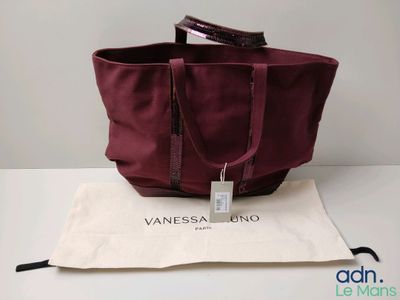 an image of a bag with a tag on it sitting on a table