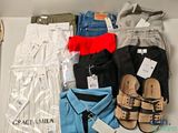 a lot of clothes and shoes on a table