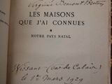 an old book with writing on it sitting on top of a table