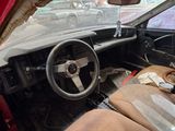 a dirty car with a steering wheel and a dirty seat