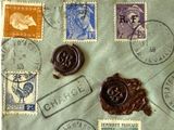 a piece of paper with stamps and a wax seal on it