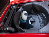 a bottle of water in the engine compartment of a red car