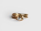 a close up of a gold ring with a clear stone