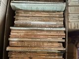 a box full of old books sitting on top of a table
