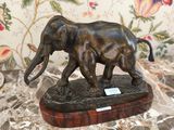 une statue représentant un éléphant et un éléphanteau posée sur une table en marbre
