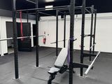 an image of a gym room with a bench and a football field