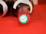 two bottles of wine sitting on a red table