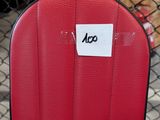 a close up of a red chair with a sticker on it