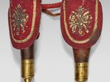 pair of red and gold decorated wall sconces on a white background
