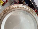 a white bowl with gold designs on the rim