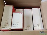several boxes of electronic devices in a cardboard box on a table