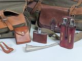 many different types of leather and canvas bags on the table