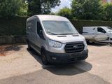 a silver van parked in a parking lot next to a white van