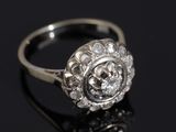 a close up of a diamond ring on a black surface