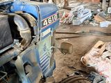 a tractor that is sitting in a room with bricks