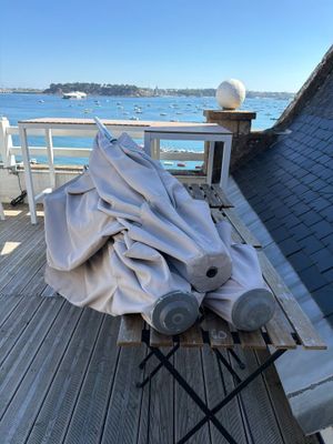 a table with a cloth on it sitting on a deck