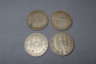 four different coins sitting on top of a table next to each other